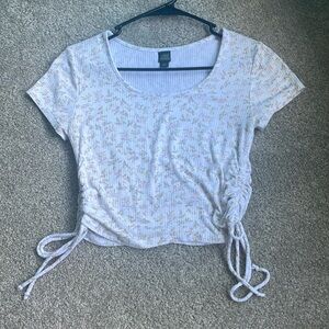 White cropped top, with a light pink flower pattern. Size medium.